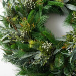 Detail view of layered greenery detail from the Seeded Eucalyptus and Christmas Pine Door Holiday
