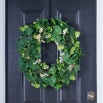 Alternate angle of the Everyday Mixed Greenery Geranium, Clover All Seasons Wreath showing wreath face