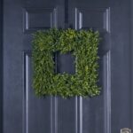 Alternate angle of the Soft Touch Green Boxwood Square Front Door Wreath showing wreath face