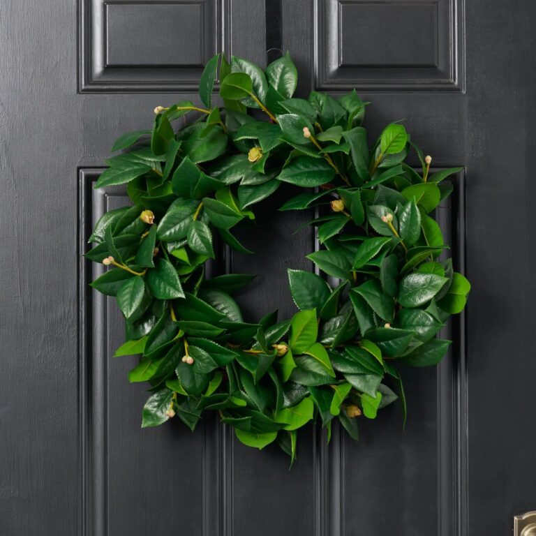 Close-up of blooms and berries on this Lifelike All Seasons Camellia Leaf Front Door Wreath