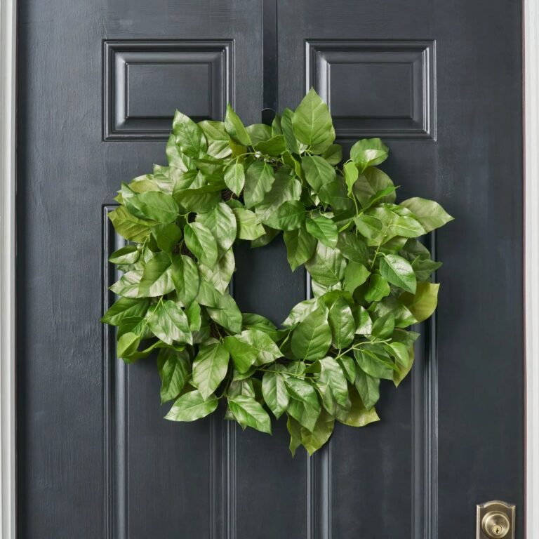 Close-up of blooms and berries on this Real Touch Salal Leaf UV Door Greenery Wreath