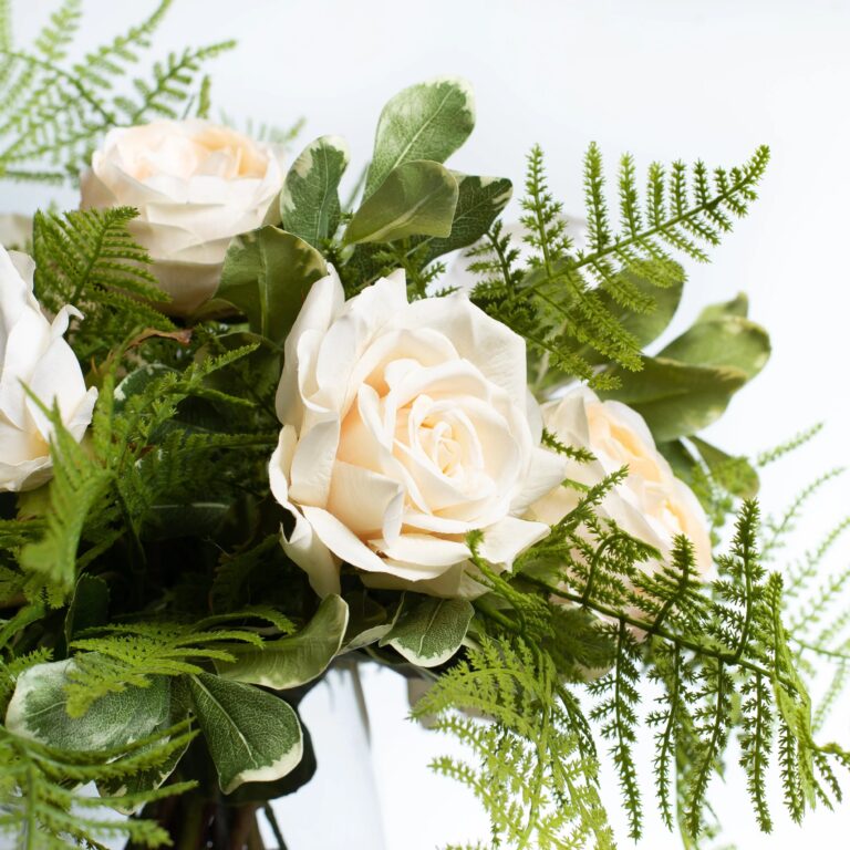 Close-up of vase silhouette detail on this Cream Mixed Real Touch Roses Tapered Vase