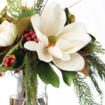 Alternate angle of the White Christmas Magnolia, Red Winter Cylindrical Glass Vase showing bloom arrangement