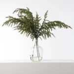 Alternate angle of the Real Touch Green Norfolk Pine Branch Christmas Spray showing leaves along