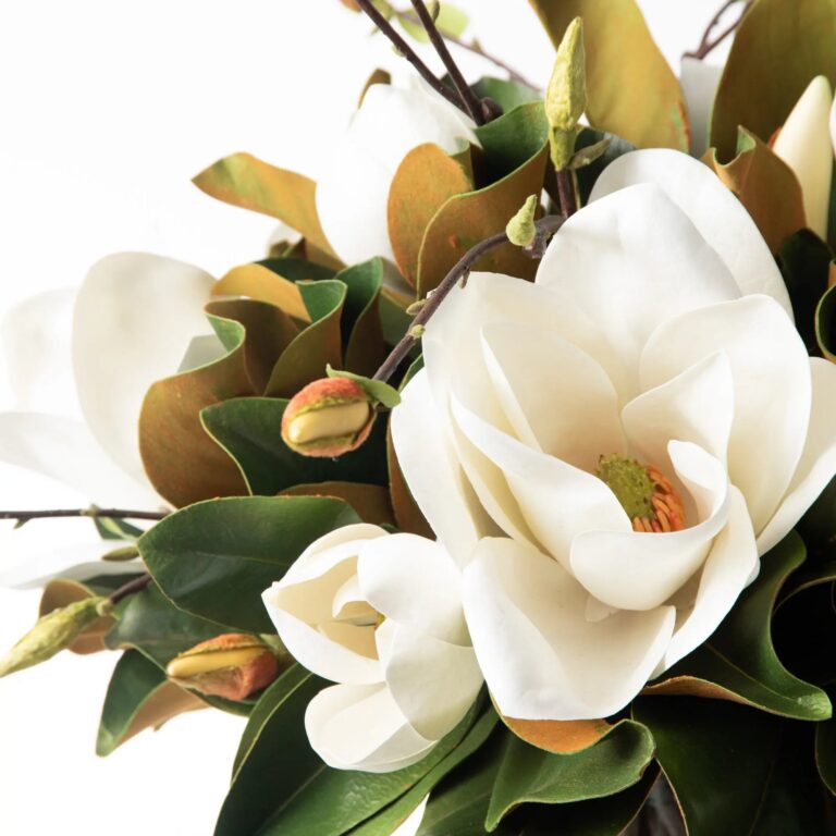 Close-up of vase silhouette detail on this Southern Elegance Real Touch Magnolia Water Illusion Arrangement