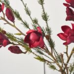 Close-up of vase silhouette detail on this Real Touch Burgundy Red Magnolia Christmas Floral Arrangement