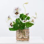 Close-up of leaf foliage texture on this Lifelike Pansy Plant In Rattan Rattan Wrapped Vase