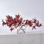 Alternate angle of the Lifelike Red Japanese Maple Branches Water Illusion Arrangement showing bloom arrangement