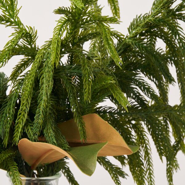 Close-up of vase silhouette detail on this Real Touch Norfolk Pine Greenery Holiday Arrangement