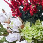 Close-up of vase silhouette detail on this Festive Holiday Blooms - Red Vase Christmas Arrangement