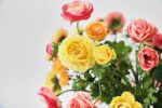 Close-up of vase silhouette detail on this Mixed Sunrise Ranunculus - Yellow, Water Illusion Arrangement