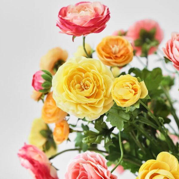 Close-up of vase silhouette detail on this Mixed Sunrise Ranunculus - Yellow, Water Illusion Arrangement