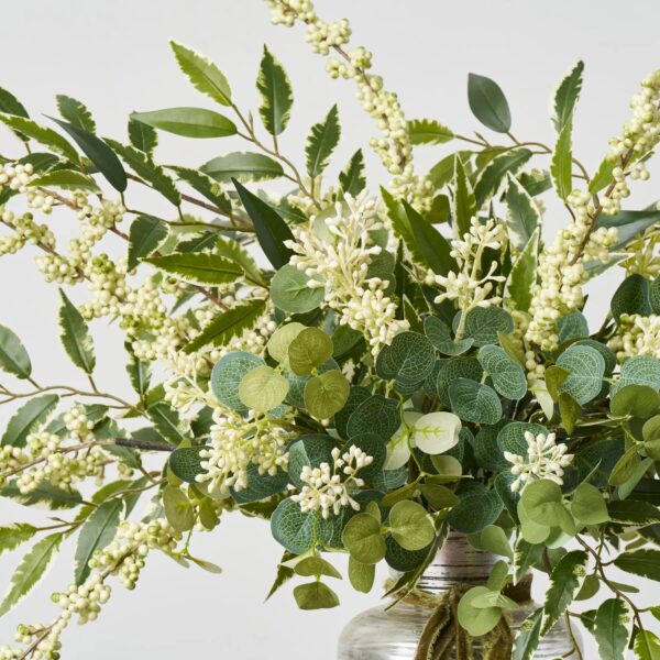 Close-up of vase silhouette detail on this Variegated Smilax, Seeded Eucalyptus Velvet Bow