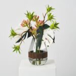 Alternate angle of the Tropical Muse - Green Albino Illusion Centerpiece Arrangement showing bloom arrangement