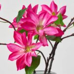 Close-up of vase silhouette detail on this Real Touch Fuchsia Pink Clematis Water Illusion Arrangement