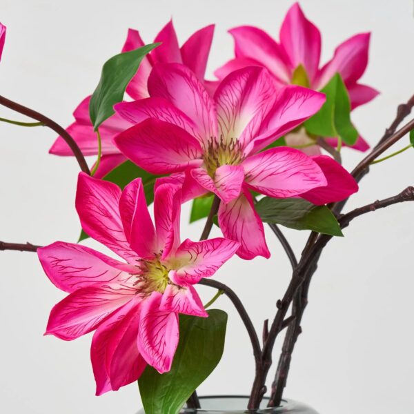 Close-up of vase silhouette detail on this Real Touch Fuchsia Pink Clematis Water Illusion Arrangement