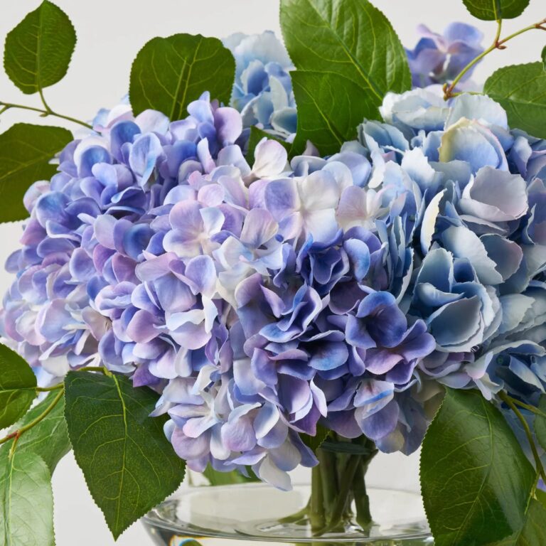 Close-up of vase silhouette detail on this Lifelike Blue Violet Mixed Large Water Illusion Arrangement