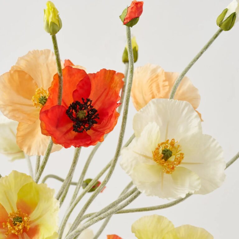 Close-up of vase silhouette detail on this Poppy Sunrise for Daphne Water Illusion Arrangement