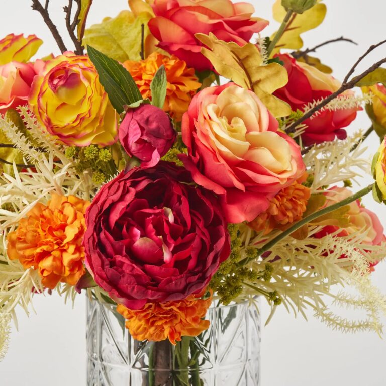 Close-up of vase silhouette detail on this Autumn Sunrise Blooms - Red Water Illusion Arrangement