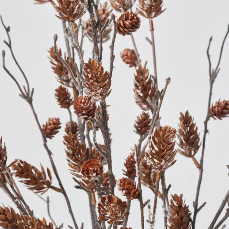 Close-up of vase silhouette detail on this Lifelike Snow Dusted Pinecone Branch illusion Centerpiece Arrangement