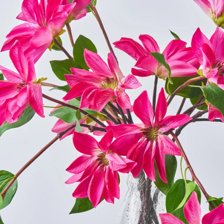 Close-up of vase silhouette detail on this Climbing Real Touch Cerise Pink Spring Table Arrangement