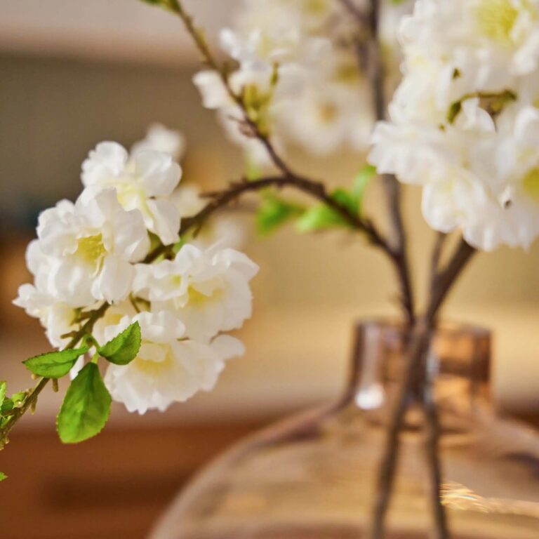 Close-up of vase silhouette detail on this Lifelike Wild Cherry Blossom White Water Illusion Arrangement