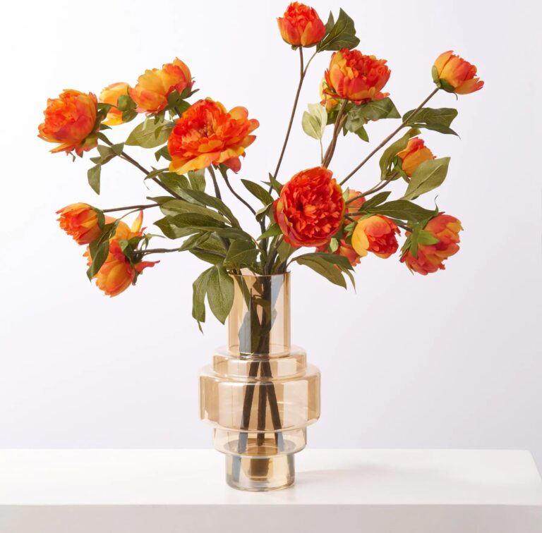 Close-up of vase silhouette detail on this Lifelike Fall Orange Peony Blooms Water Illusion Arrangement