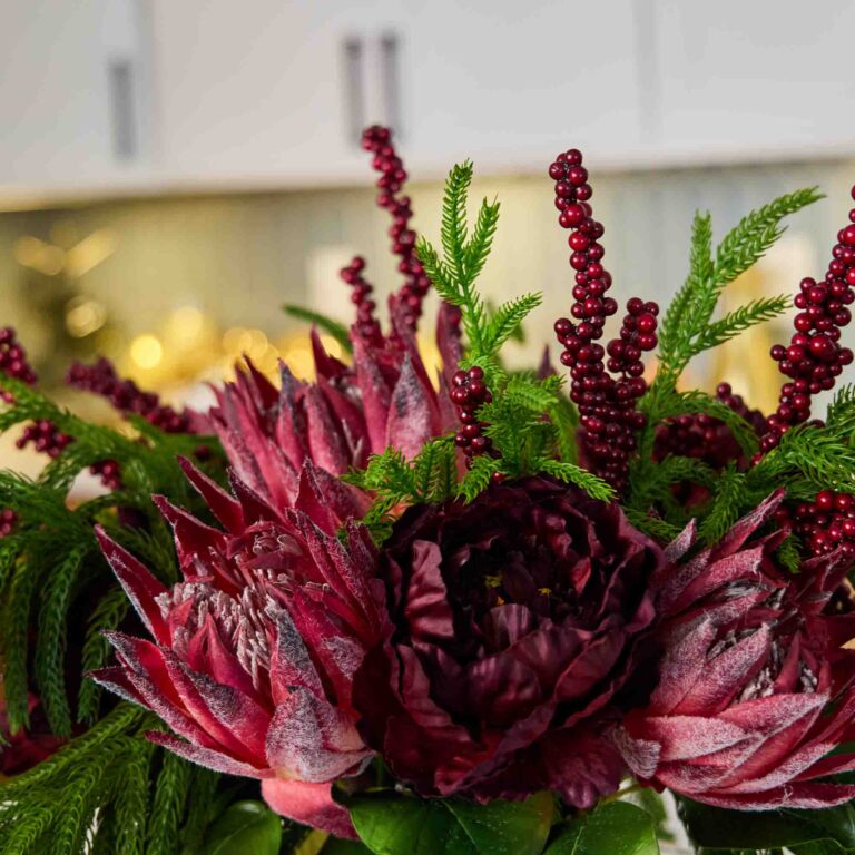 Close-up of vase silhouette detail on this Winter Majesty - Burgundy King Illusion Centerpiece Arrangement