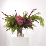 Alternate angle of the Winter Majesty - Burgundy King Illusion Centerpiece Arrangement showing bloom arrangement