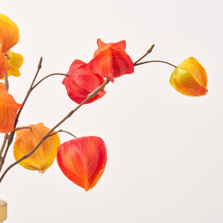 Close-up of vase silhouette detail on this Orange and Yellow Mixed Fall Water Illusion Arrangement