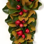 Close-up of swag tail detail on this Real Touch Magnolia Leaf Door Christmas Swag Holiday