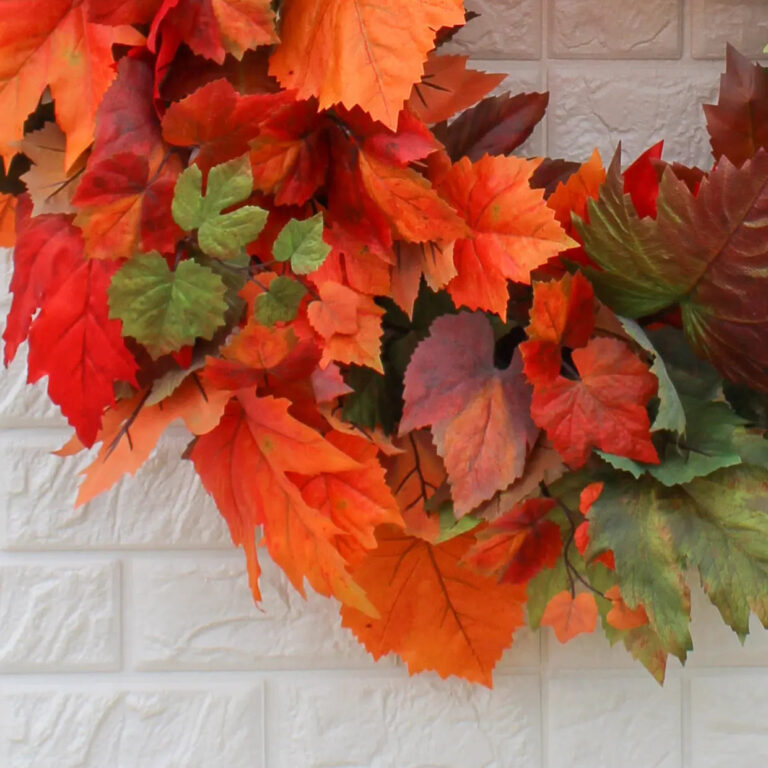 Close-up of blooms and berries on this Orange and Green Ombre Maple Fall 28' Wreath