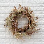 Detail view of layered greenery detail from the Cream Dried - Look Olive Door Fall