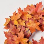Close-up of blooms and berries on this Red and Orange Autumnal Two Door Mantle Wreath