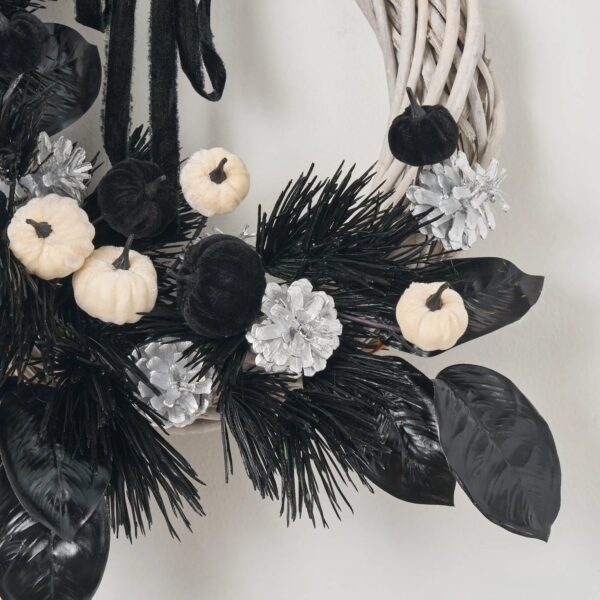 Close-up of blooms and berries on this Macabre Magnolia - Black Jagged Door Mantle Wreath