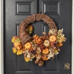 Alternate angle of the Harvest Homecoming - Artichoke, Pumpkin, Thanksgiving Cornucopia Wreath showing wreath face