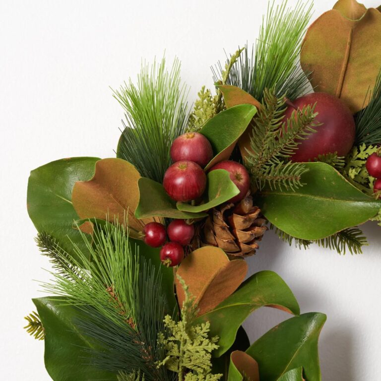 Close-up of blooms and berries on this Real Touch Magnolia, Pine, Faux Front Door Wreath