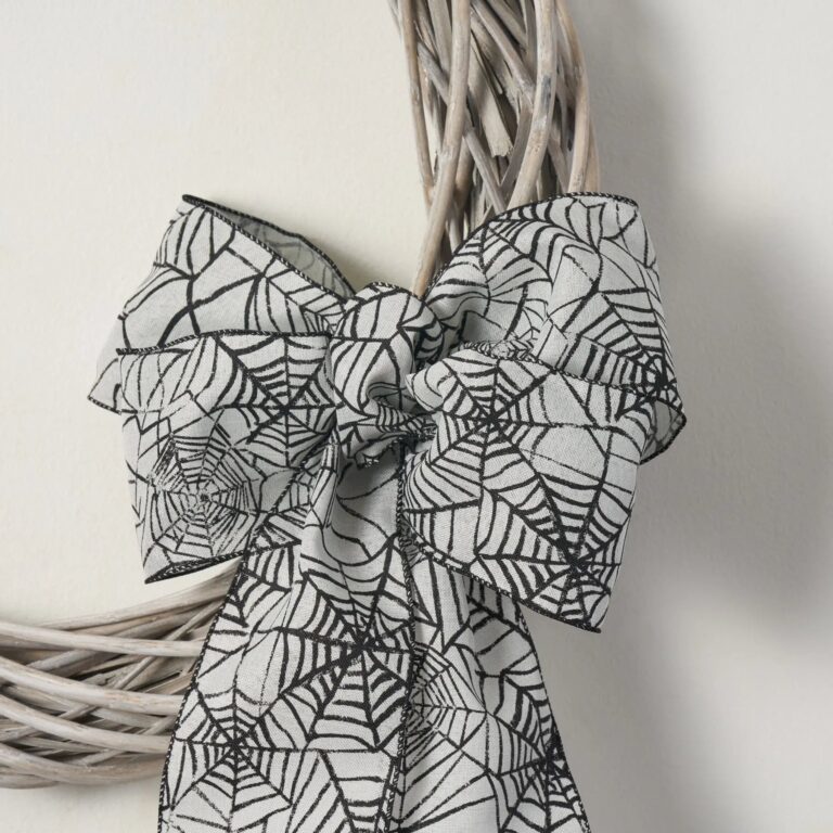 Close-up of blooms and berries on this White Washed Wicker Willow Wreath Spiderweb Halloween Bow