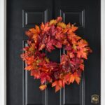 Detail view of layered greenery detail from the Autumn Blaze Red Maple Door Mantel Wreath