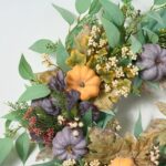 Close-up of blooms and berries on this Fall Orange and Purple Pumpkin, Door Autumn Wreath