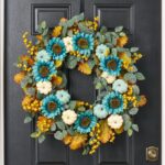 Close-up of blooms and berries on this Pumpkins by the Sea Front Door Wreath