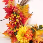 Close-up of blooms and berries on this Vision of Autumn - Mixed Front Door Wreath