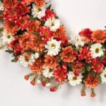 Close-up of blooms and berries on this Zinnia Mum Cream, Orange Floral Thanksgiving Wreath