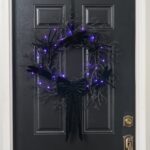 Close-up of blooms and berries on this Creatures of the Night Fall Halloween Wreath