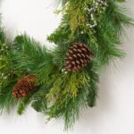 Close-up of greenery along the garland on this Classic Holiday Greens and Pinecone Front Door