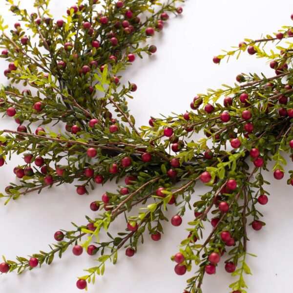 Close-up of greenery along the garland on this Wild Cranberry and Leaf Holiday Table Runner