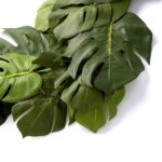 Close-up of greenery along the garland on this Split Philodendron Monstera Leaf Green Runner Mantle