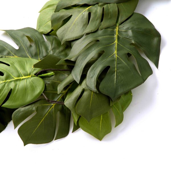 Close-up of greenery along the garland on this Split Philodendron Monstera Leaf Green Runner Mantle