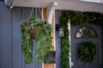 Side view of the Seeding Real Touch Juniper Berry Door Mantle Wreath revealing frame and