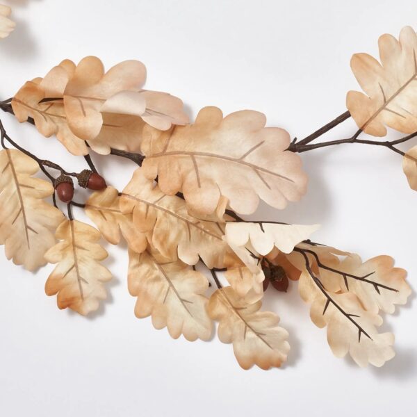 Close-up of greenery along the garland on this Bleached Cream Oak Leaf Fall Mantel Garland